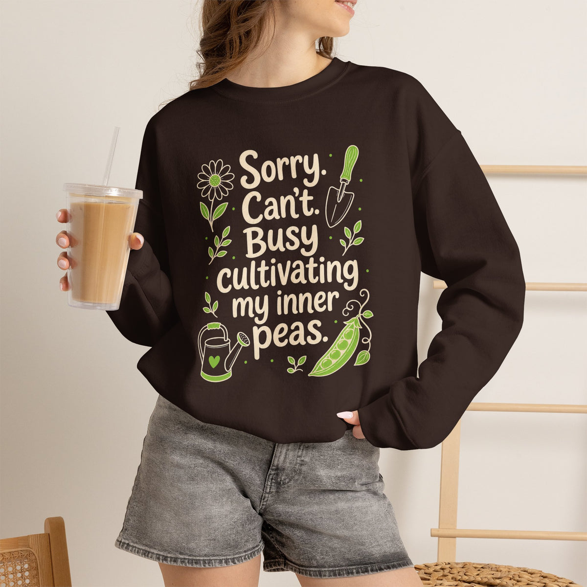 Lifestyle mockup of the Sorry Can't Busy Cultivating My Inner Peas Gildan 18000 sweatshirt.